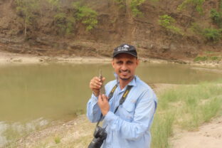 Ashish Bashyal holding a juvenile gharial